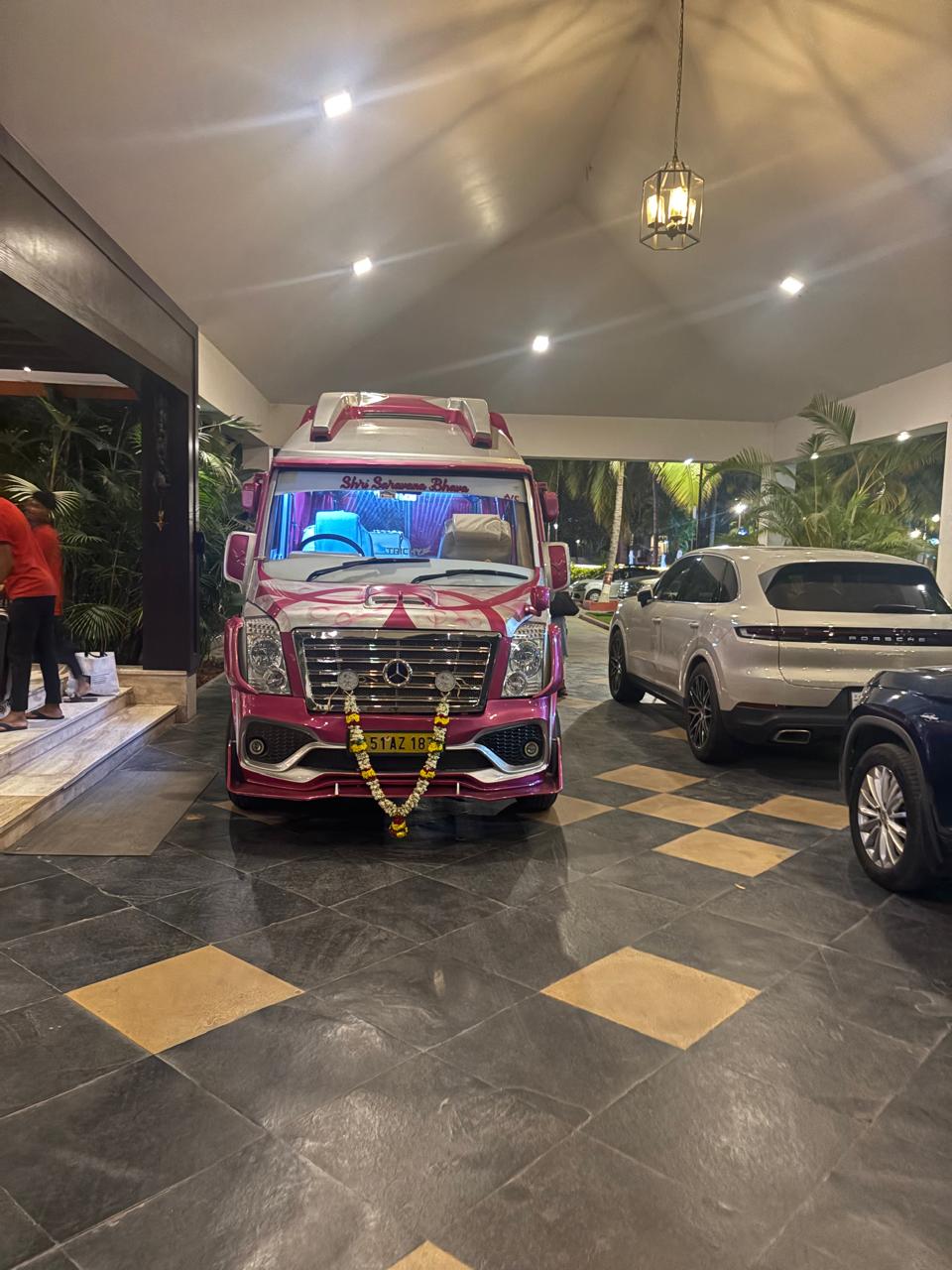 Front view of Force Tempo Traveller at night hotel pickup